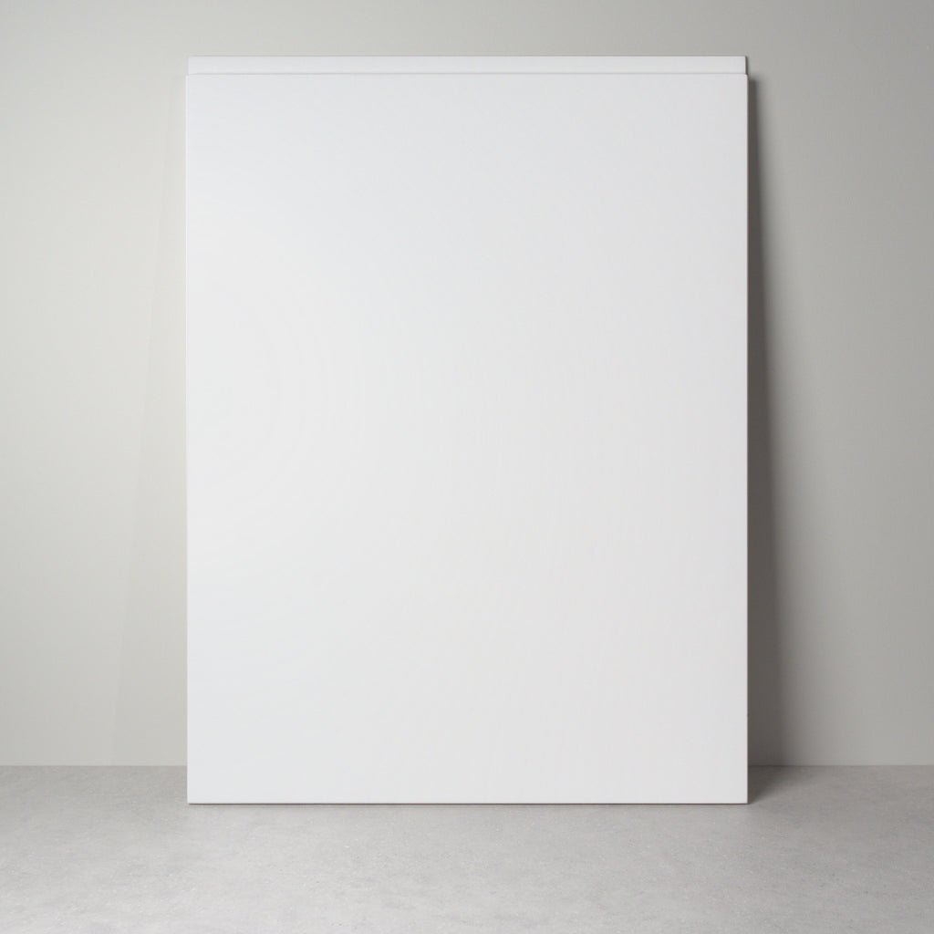 Milled Handle front for IKEA furniture in white lacquer, leaning against a wall, handle undercut along the top edge