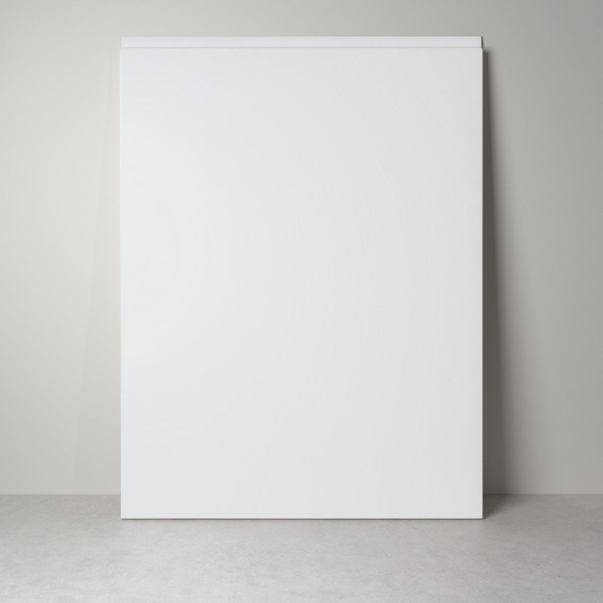 Milled Handle front for IKEA furniture in white lacquer, leaning against a wall, handle undercut along the top edge