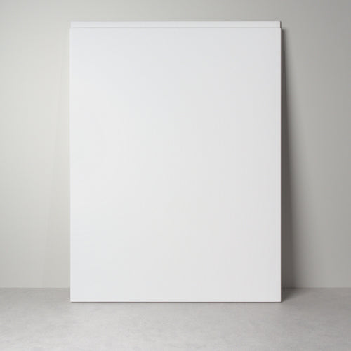 Milled Handle front for IKEA furniture in white lacquer, leaning against a wall, handle undercut along the top edge