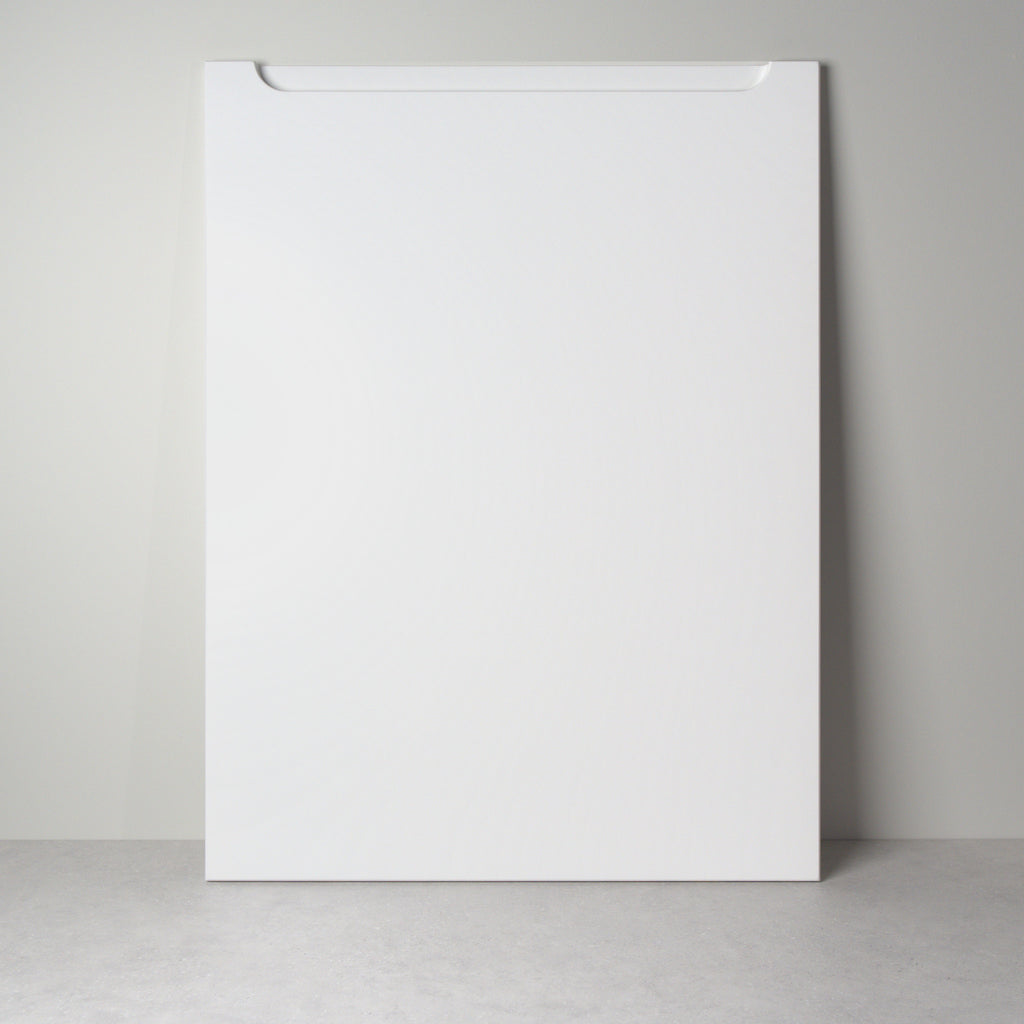 Grip front for IKEA furniture in white lacquer, leaning against a wall, milled handle pocket at the top edge