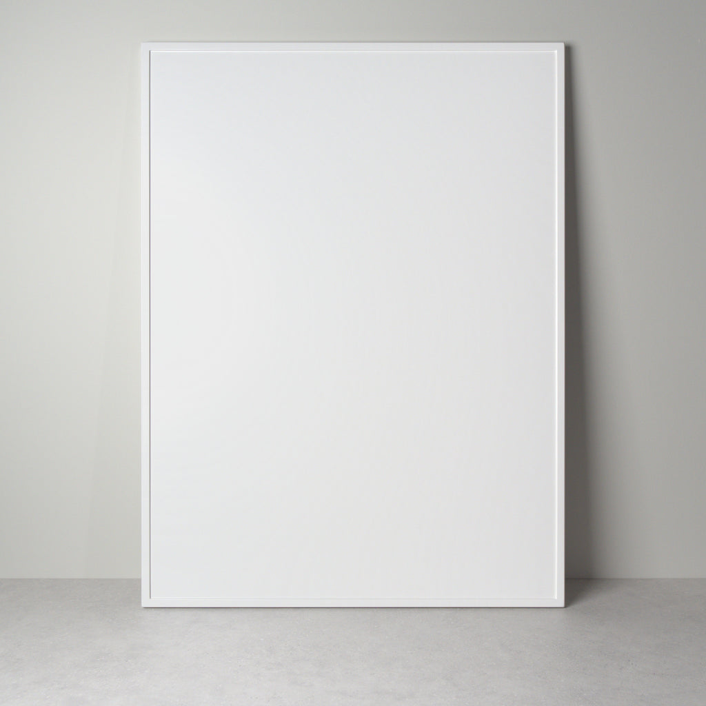 Linea front for IKEA furniture in white lacquer, a flat front with a frame along the edge, leaning against a wall