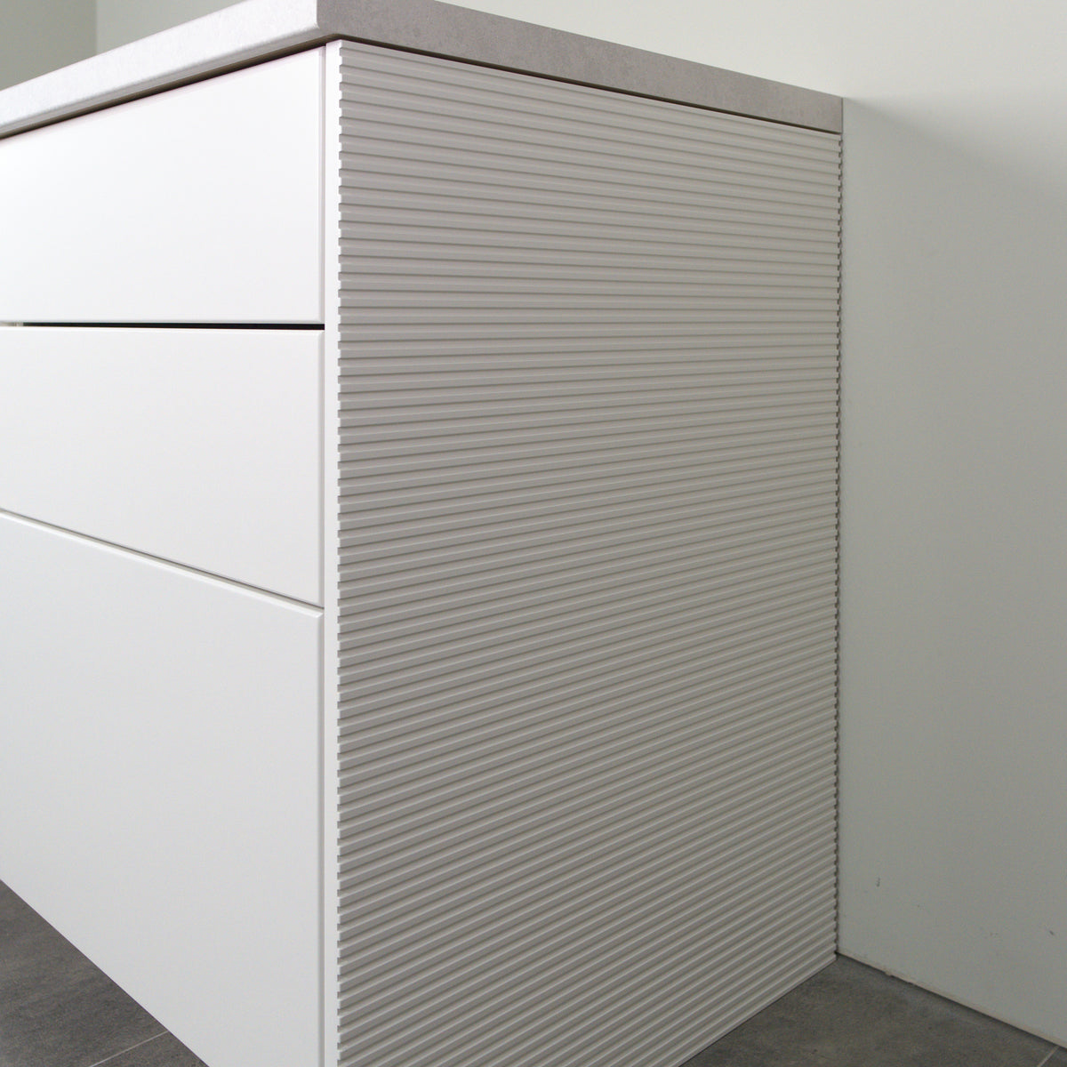 Rhythm side panel in white lacquer on a kitchen cabinet, angled view