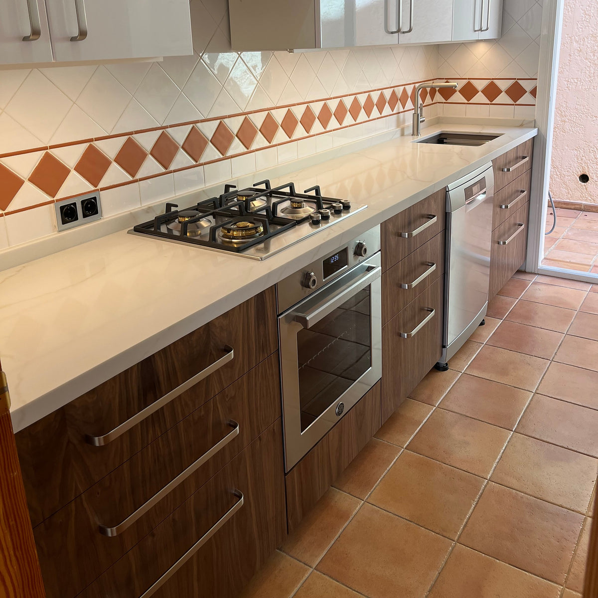 Drawers with American walnut veneer fronts under the hob and next to the oven, customer's IKEA METOD kitchen
