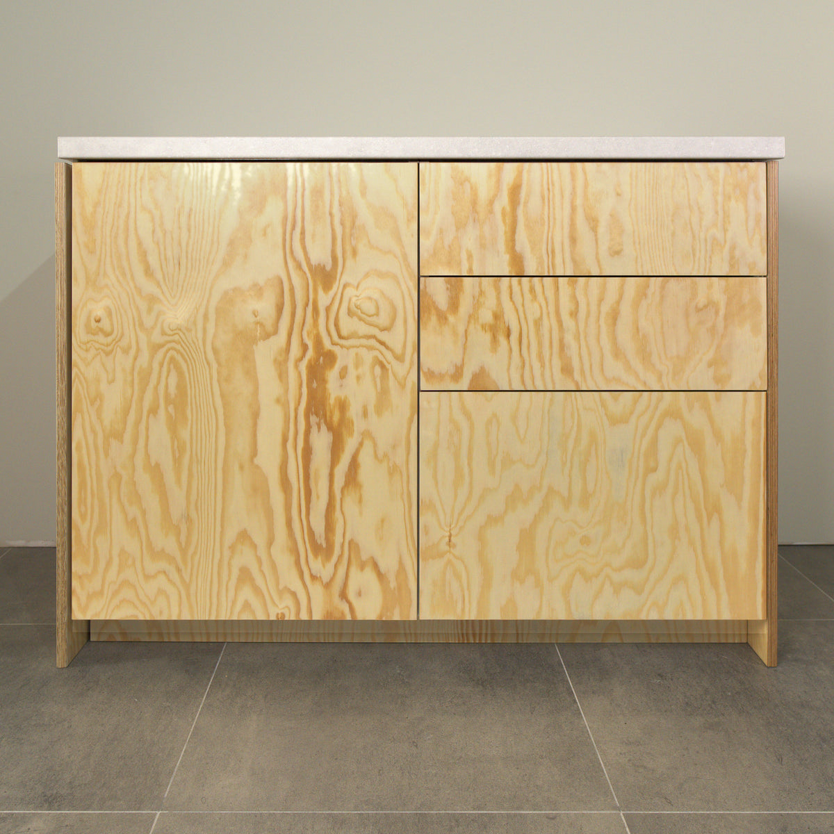 Kitchen cabinet with pine plywood fronts, a door and three drawers, front view
