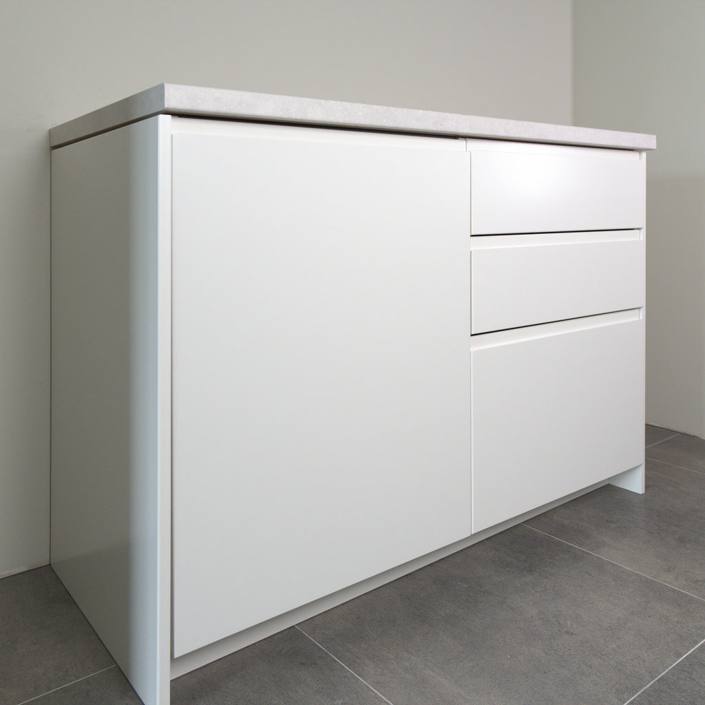 Milled Handle fronts in white lacquer on a kitchen cabinet, angled view from the left