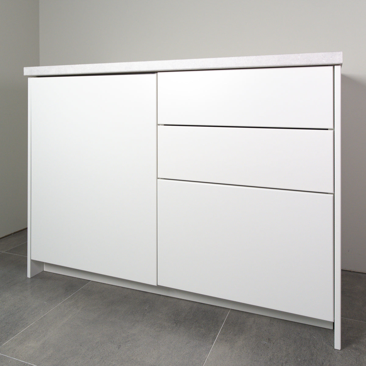 Kitchen cabinet with Smooth fronts in white lacquer, the whole cabinet with worktop, slightly angled view