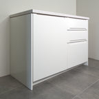 Grip fronts in white lacquer on a kitchen cabinet, angled view from the left