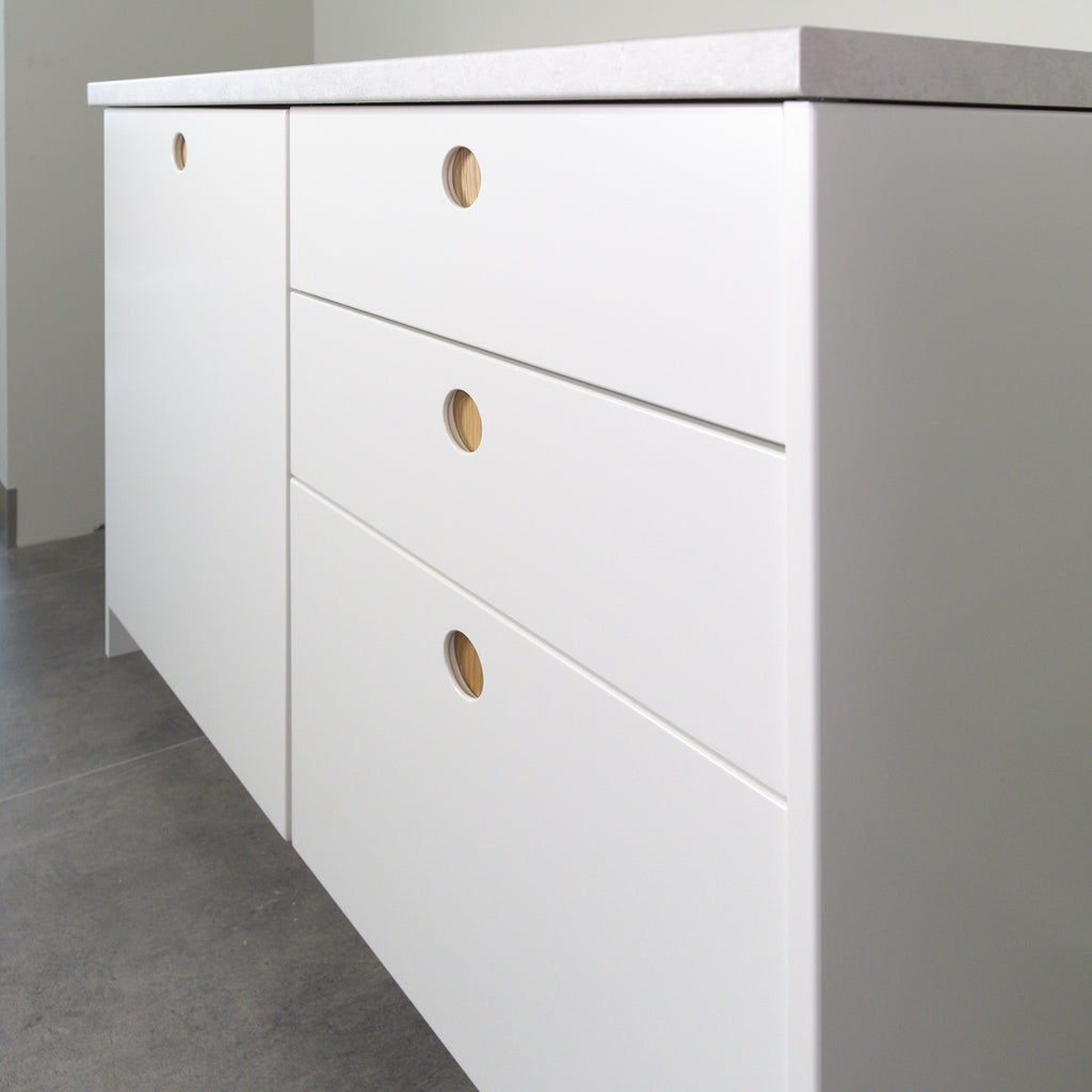 Round Oak fronts on a kitchen cabinet, angled view from the right