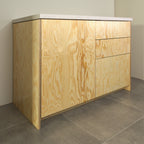Pine plywood fronts on a kitchen cabinet, angled view from the left