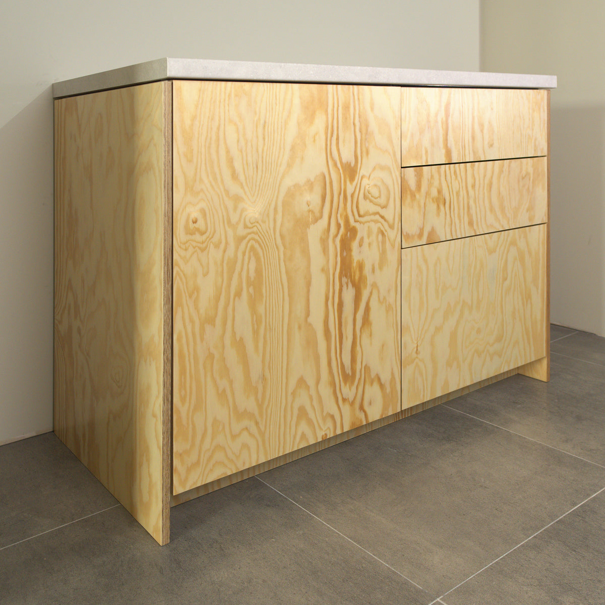 Pine plywood fronts on a kitchen cabinet, angled view from the left