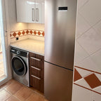 Three drawers with American walnut veneer fronts next to the washing machine, customer project