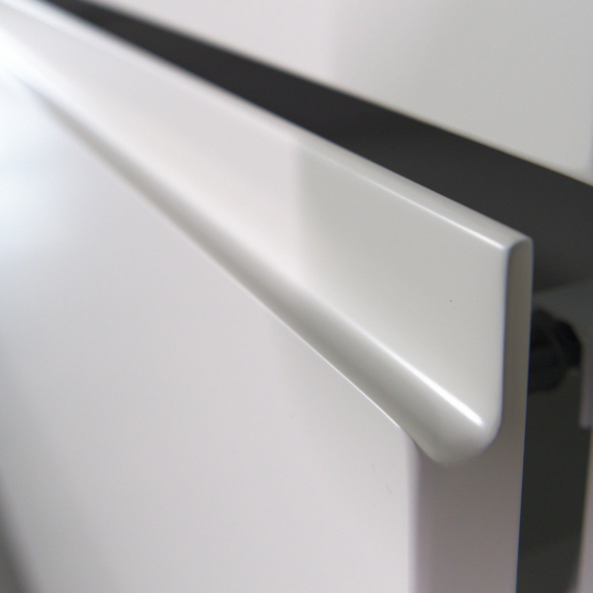 Open drawer with a Milled Handle front, profile of the handle undercut in the top edge