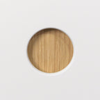 Round 50 mm handle hole lined with oak veneer in a white Round Oak front, close-up