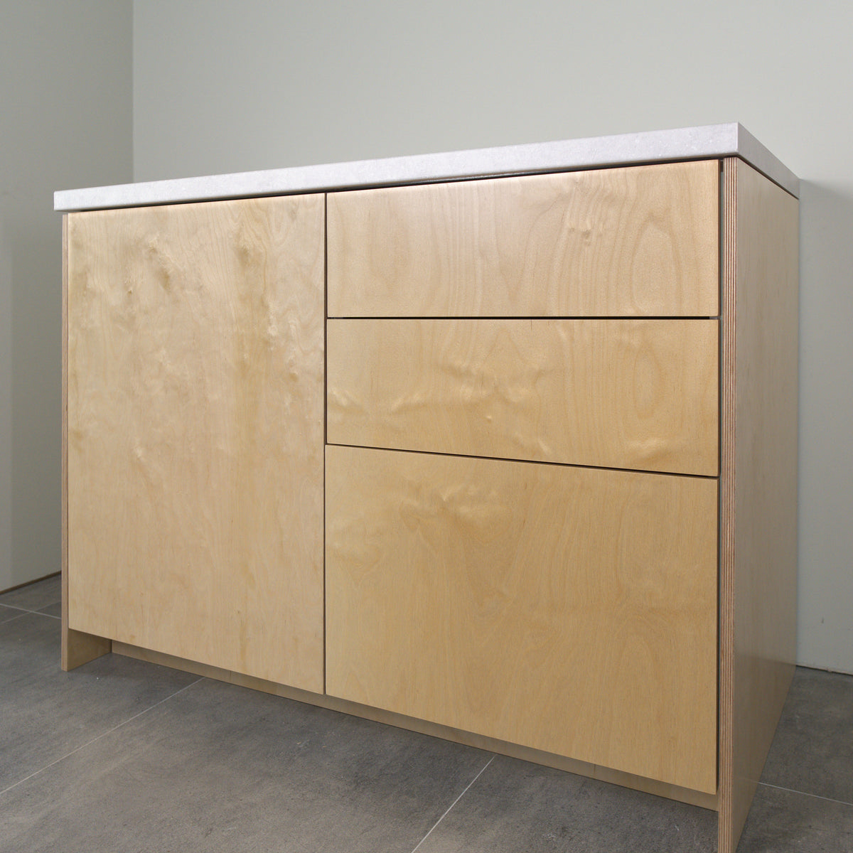 Birch plywood fronts on a kitchen cabinet, angled view from the right
