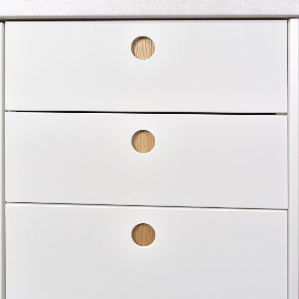 Drawers with white Round Oak fronts and round oak-lined handles, detail