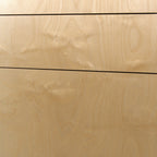 Birch plywood grain on drawer fronts, close-up