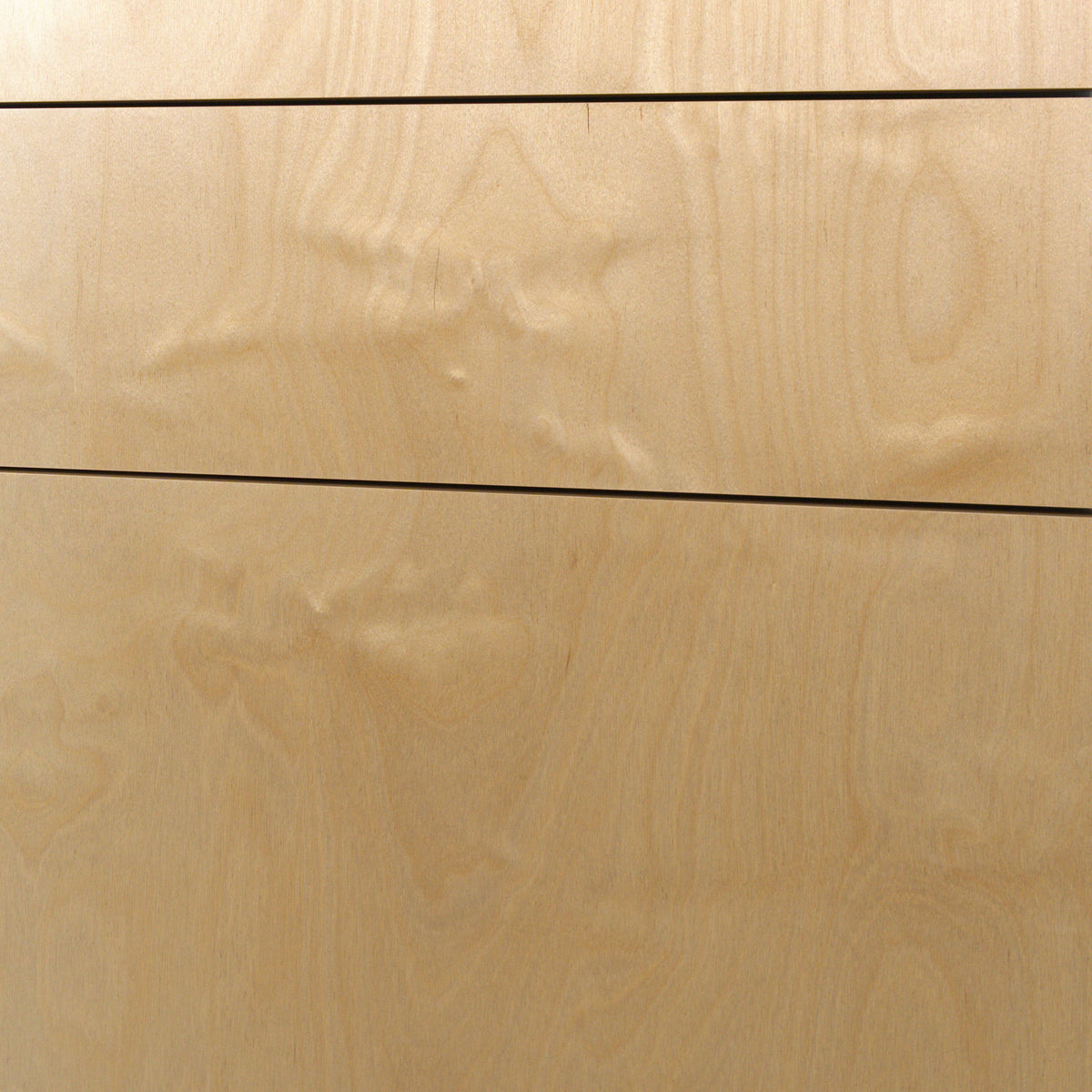 Birch plywood grain on drawer fronts, close-up