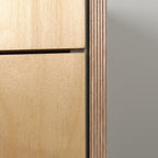 Edge of birch plywood with visible layers, side panel next to drawer fronts