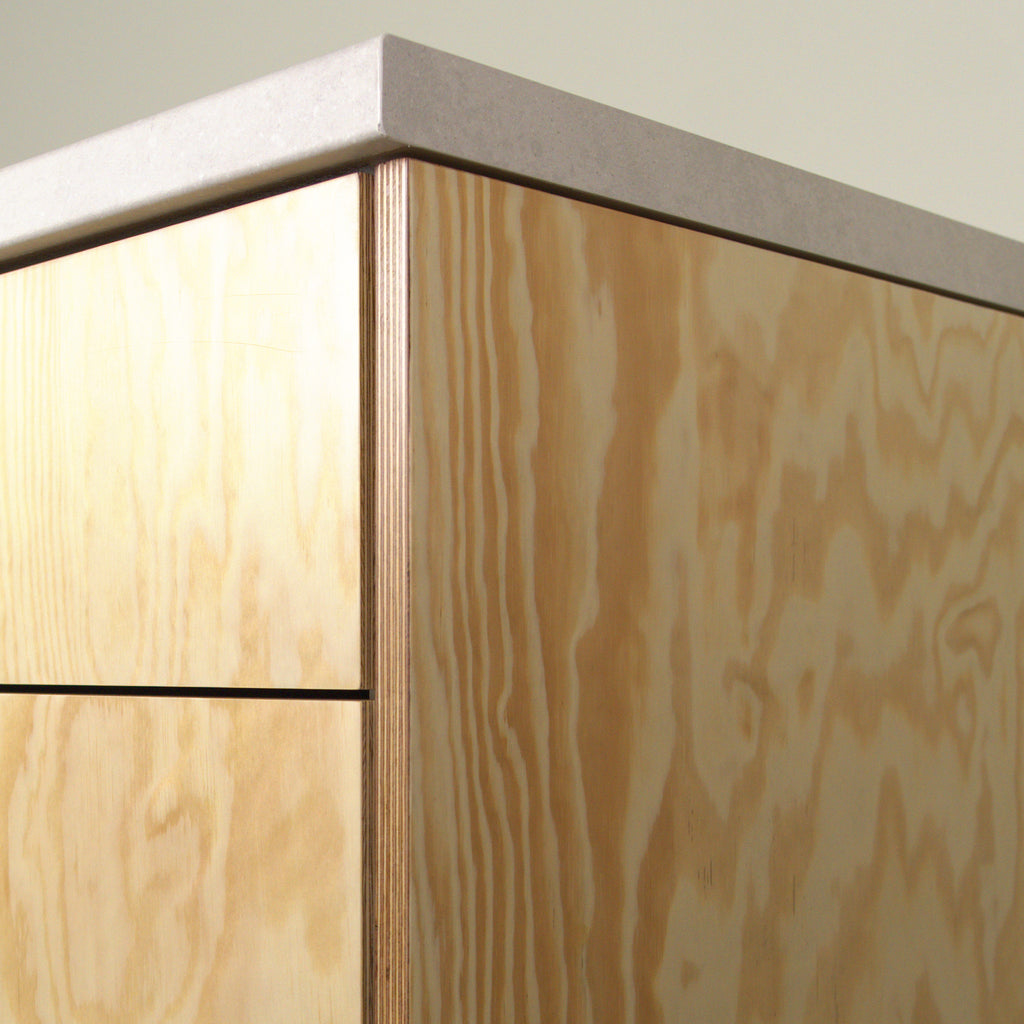 Pine plywood edge with visible layers, cabinet corner with worktop
