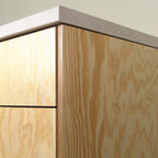 Pine plywood edge with visible layers, cabinet corner with worktop